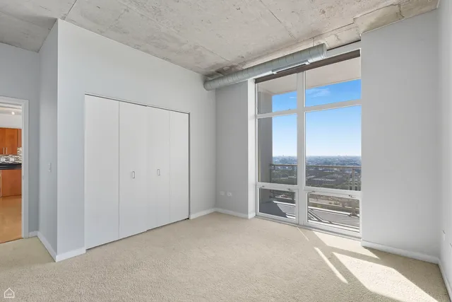 an empty room with sliding glass door and shower