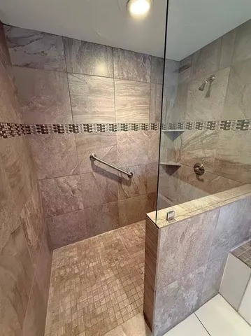 a bathroom with a shower and a sink