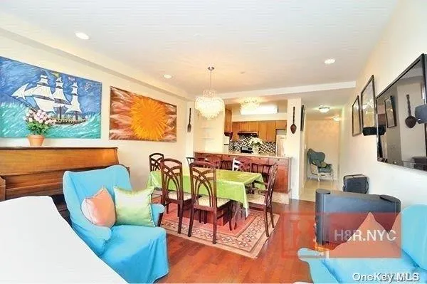 a living room with furniture kitchen view and a large window