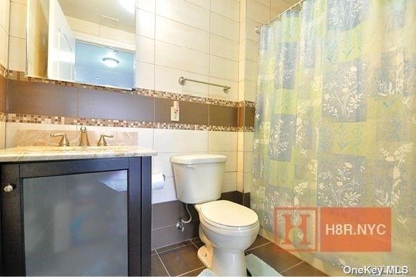 40-40 75th Street, Unit 3J Queens, NY 11373 - Photo 9 of 17 a bathroom with a toilet sink and shower