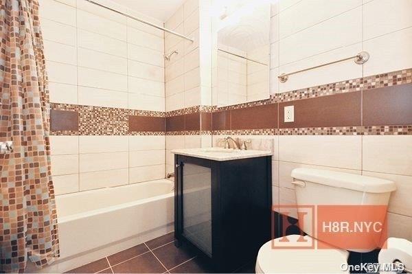 40-40 75th Street, Unit 3J Queens, NY 11373 - Photo 10 of 17 a bathroom with a sink a toilet and shower