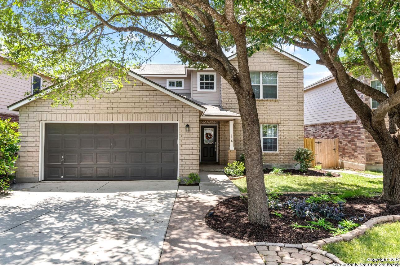 115 Woodstone Loop Cibolo, TX 78108 - Photo 1 of 1 a front view of a house with a yard and garage