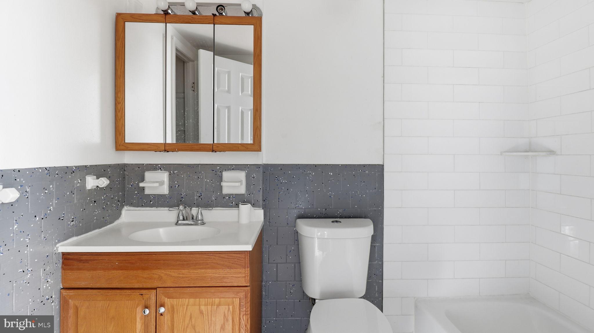 1601 Addison Road South District Heights, MD 20747 - Photo 12 of 21 a bathroom with a toilet sink and mirror