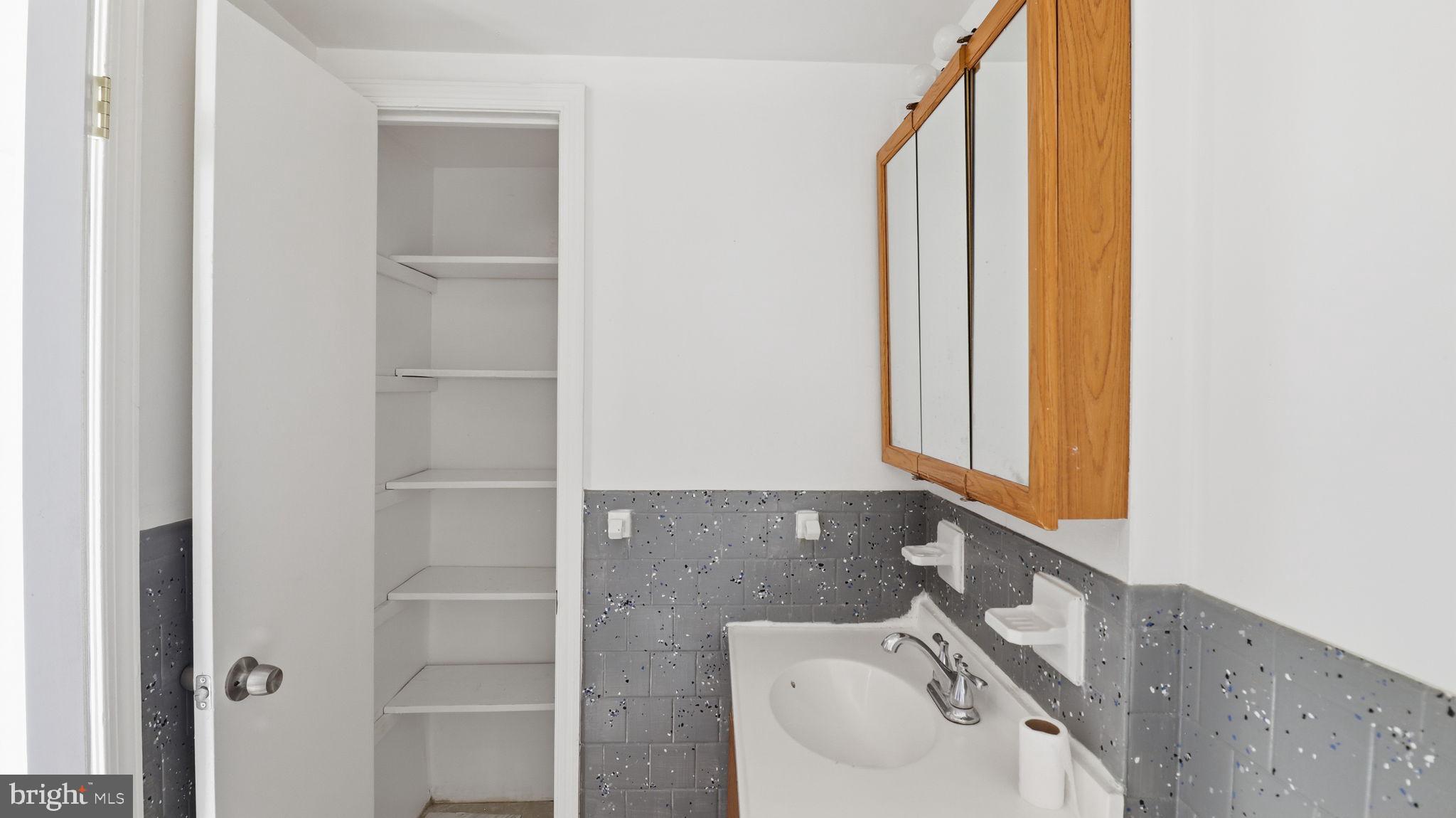 1601 Addison Road South District Heights, MD 20747 - Photo 13 of 21 a bathroom with a sink and a mirror