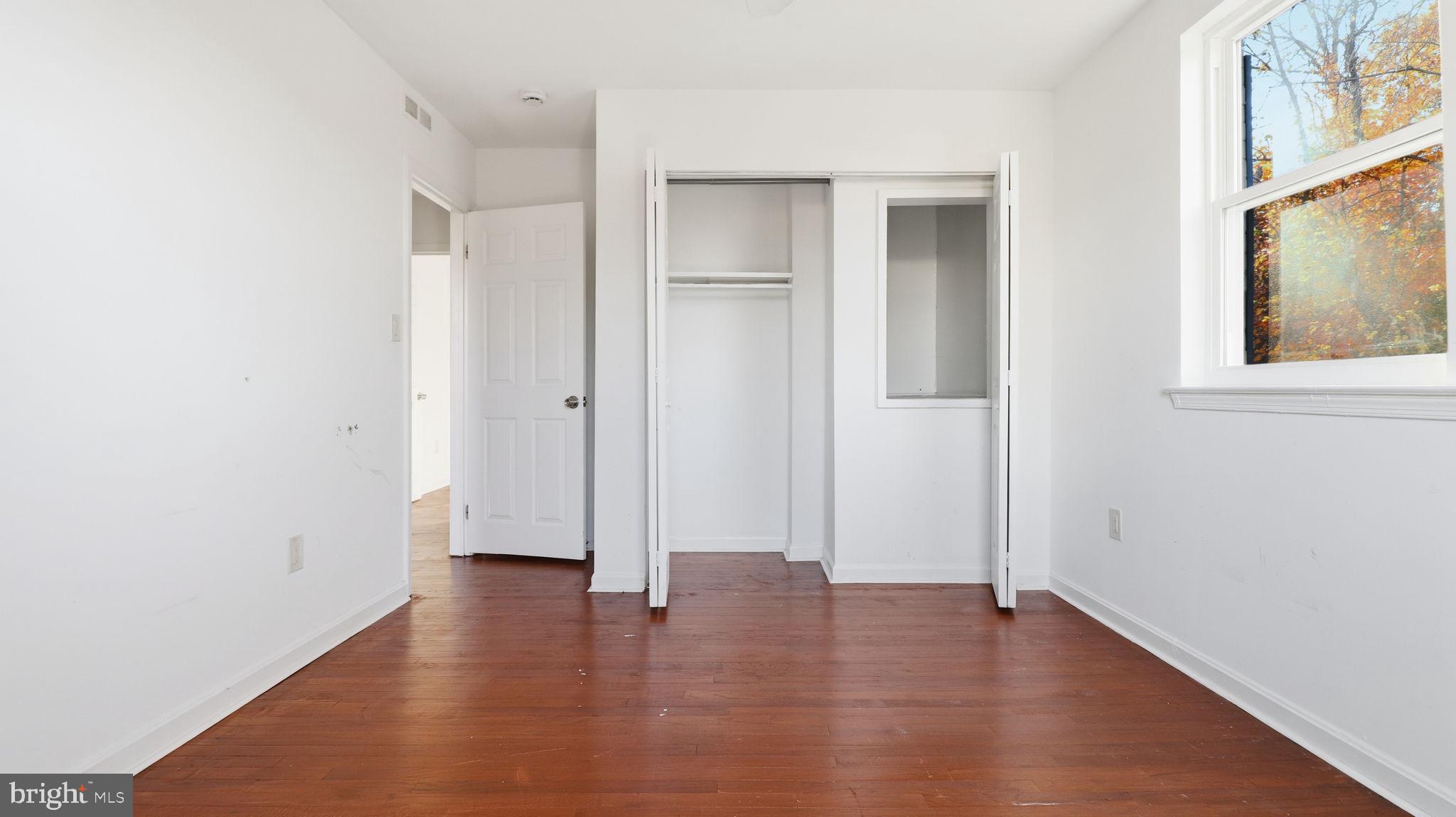 1601 Addison Road South District Heights, MD 20747 - Photo 17 of 21 a view of an empty room with wooden floor and a window