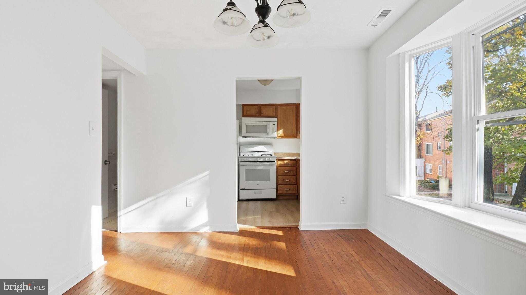 1601 Addison Road South District Heights, MD 20747 - Photo 8 of 21 a view of a hallway view with wooden floor and a dining room