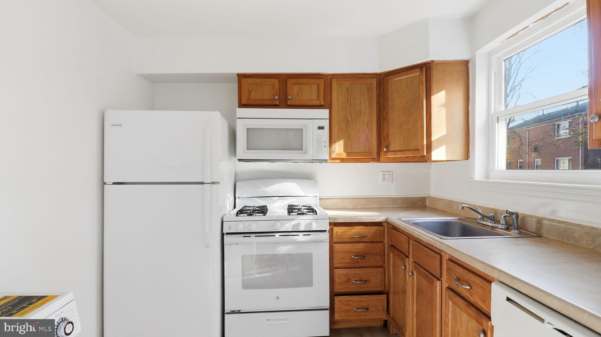 1601 Addison Road South District Heights, MD 20747 - Photo 9 of 21 a kitchen with a refrigerator and a sink