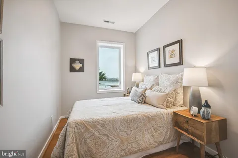 a bedroom with a bed and a lamp with window