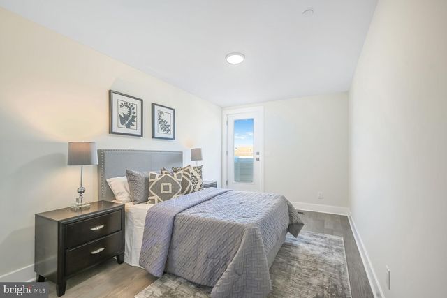 a bedroom with a bed and painting on the wall