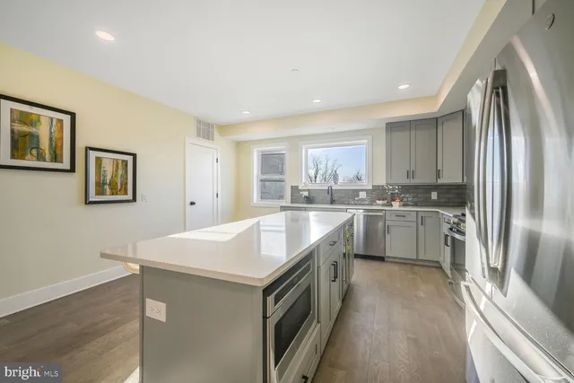 a kitchen with a sink stove and refrigerator