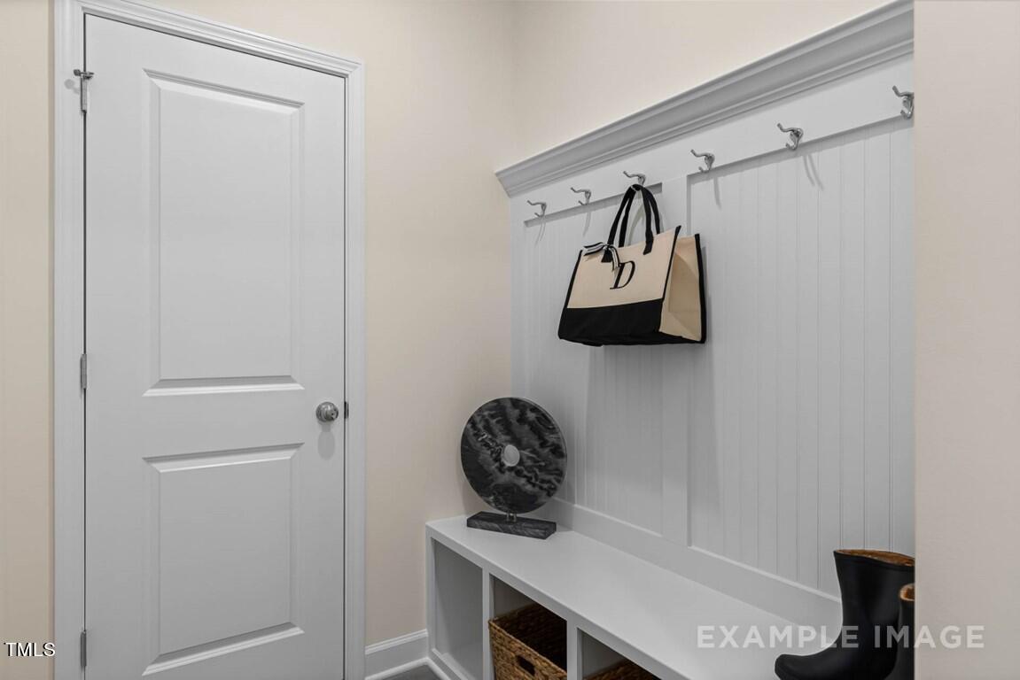 225 Highland Ridge Lane Knightdale, NC 27545 - Photo 22 of 38 a view of a hallway to room with wooden floor and windows