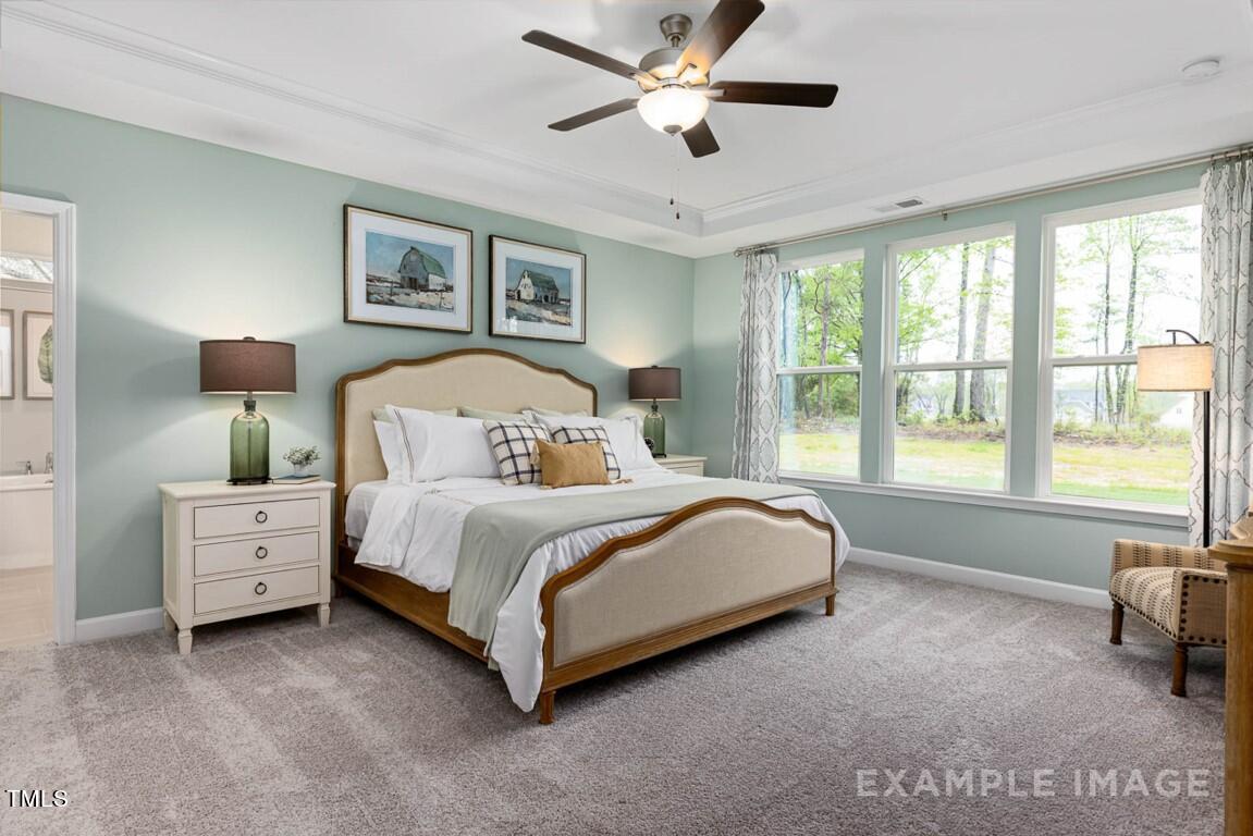 225 Highland Ridge Lane Knightdale, NC 27545 - Photo 23 of 38 a bed room with a bed and a tv