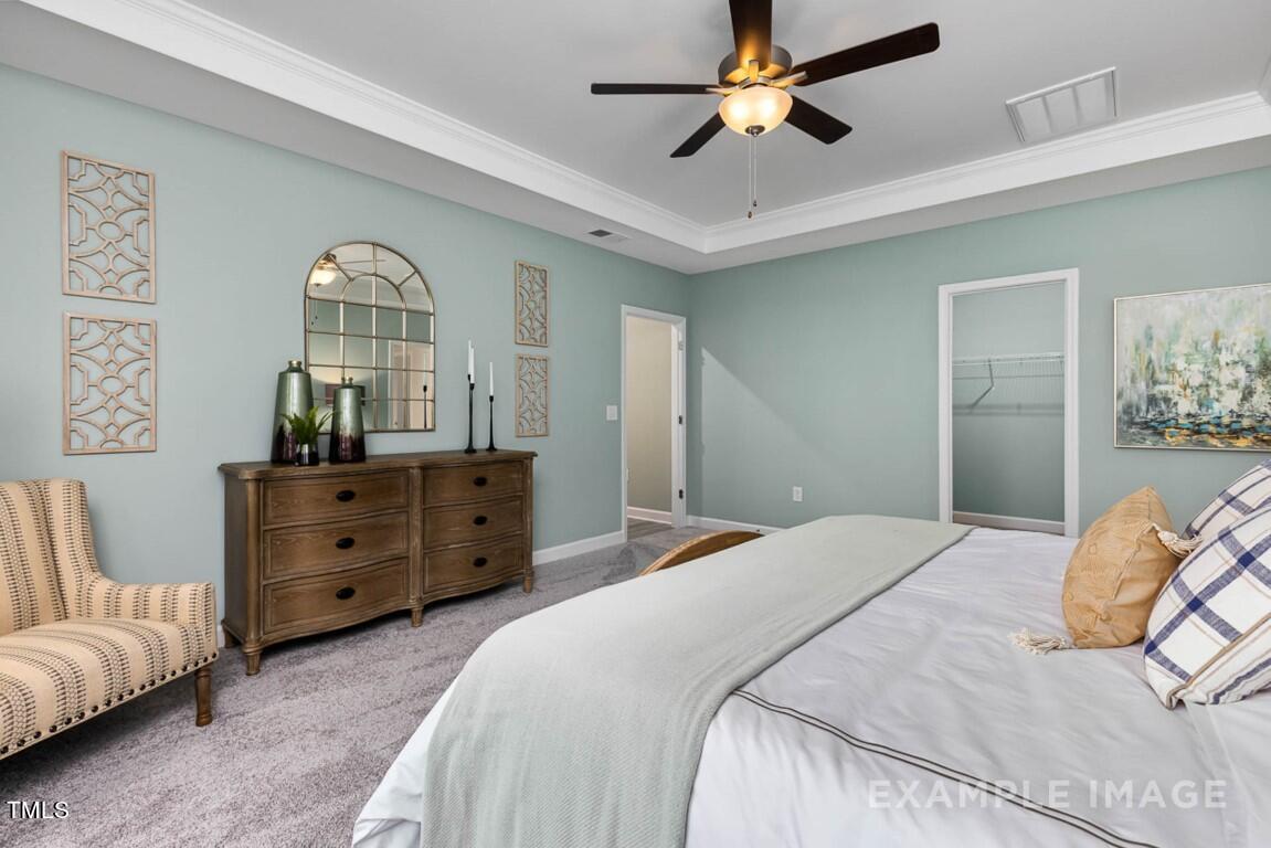 225 Highland Ridge Lane Knightdale, NC 27545 - Photo 24 of 38 a bedroom with a bed and a dresser