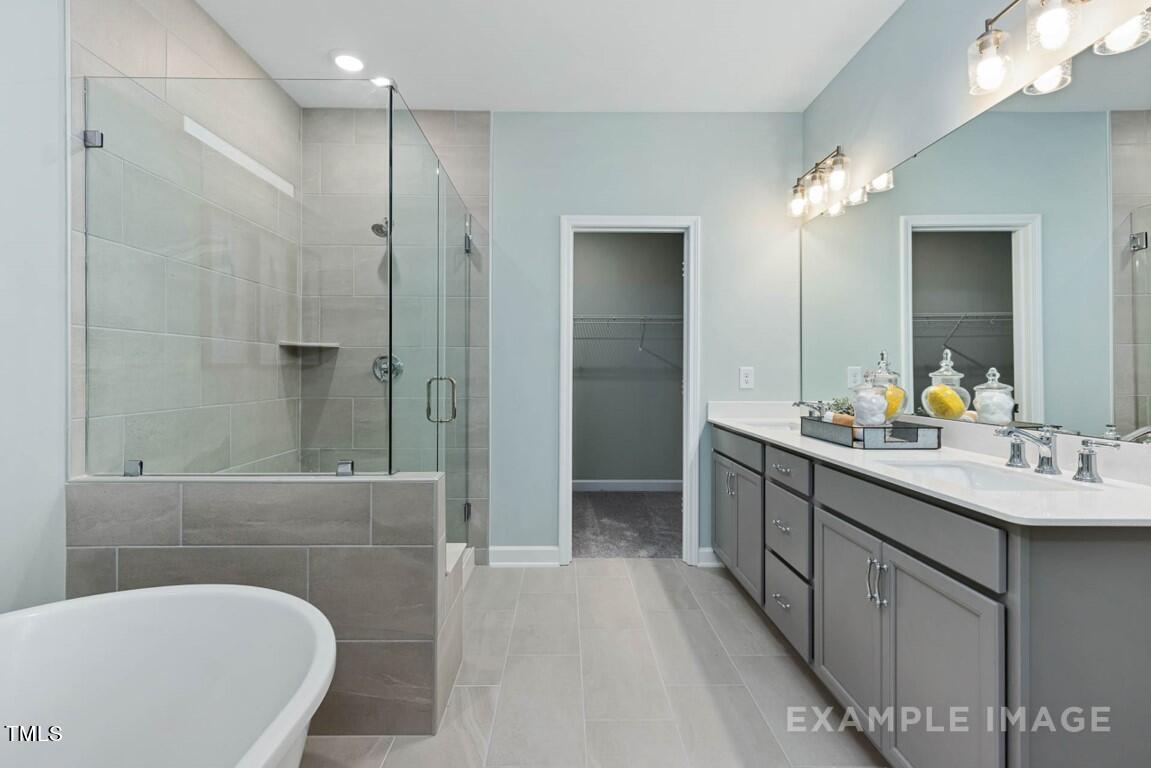 225 Highland Ridge Lane Knightdale, NC 27545 - Photo 25 of 38 a bathroom with a bathtub shower sink and mirror