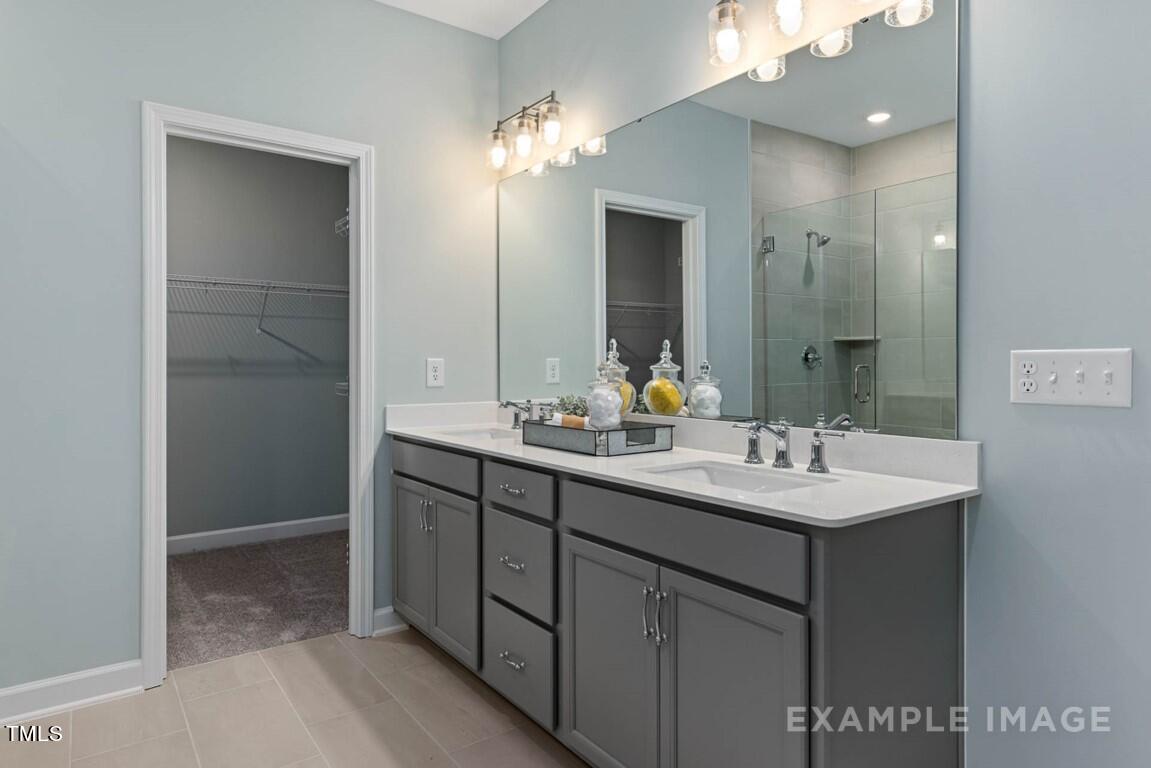 225 Highland Ridge Lane Knightdale, NC 27545 - Photo 27 of 38 a bathroom with a sink and a mirror