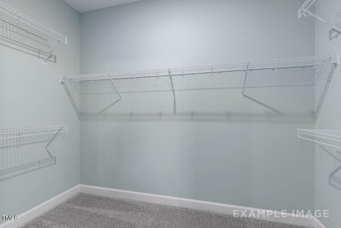 225 Highland Ridge Lane Knightdale, NC 27545 - Photo 28 of 38 a view of a room with racks on the wall