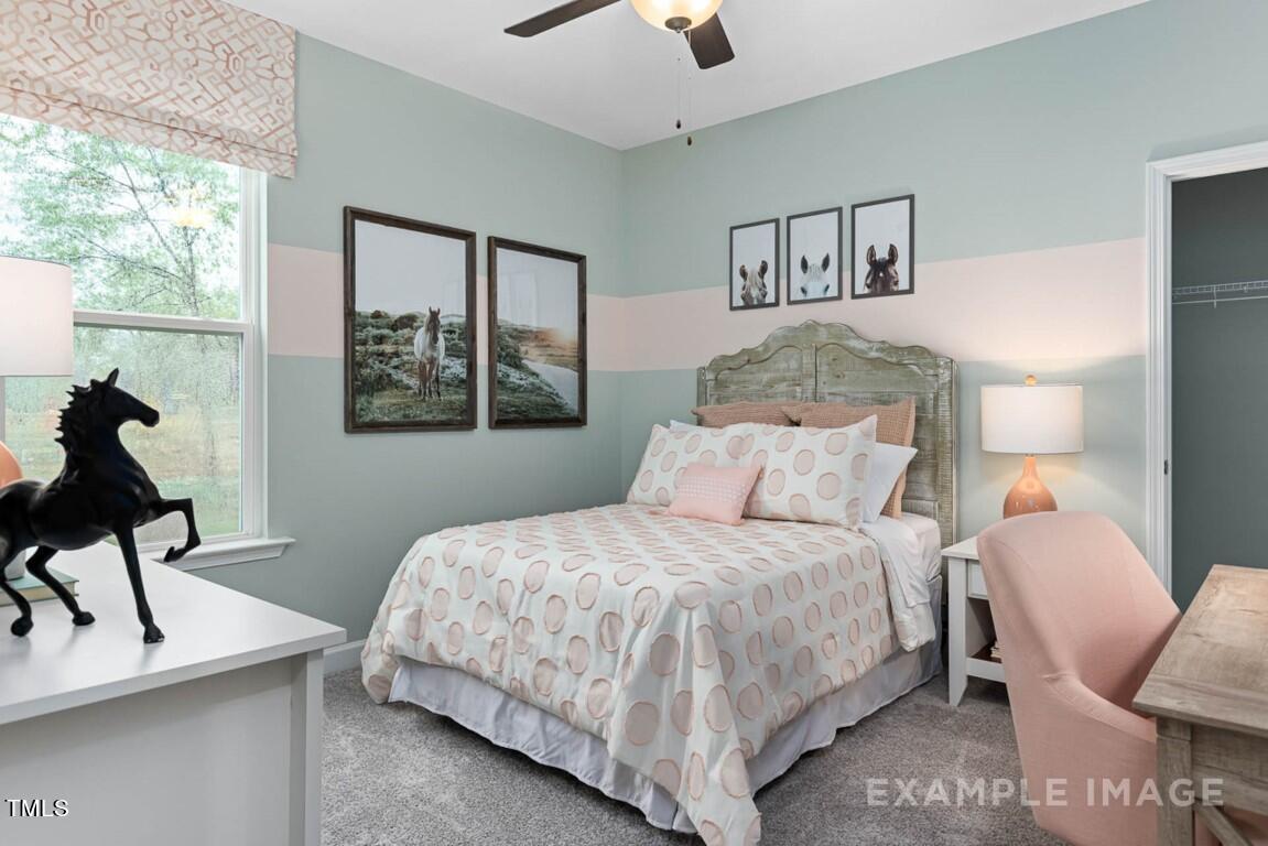 225 Highland Ridge Lane Knightdale, NC 27545 - Photo 29 of 38 a bedroom with a bed wooden floor and window