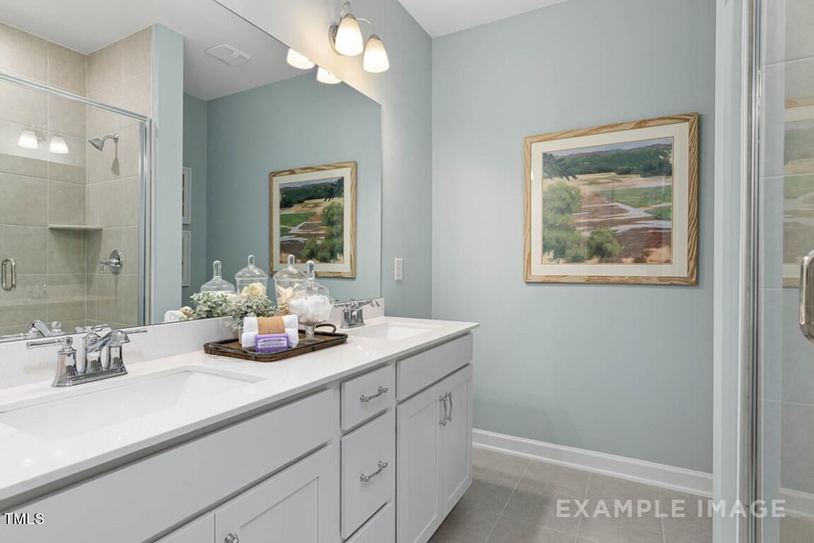 225 Highland Ridge Lane Knightdale, NC 27545 - Photo 31 of 38 a bathroom with a sink a vanity and a mirror