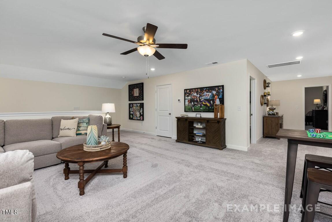 225 Highland Ridge Lane Knightdale, NC 27545 - Photo 35 of 38 a living room with furniture and a wooden floor