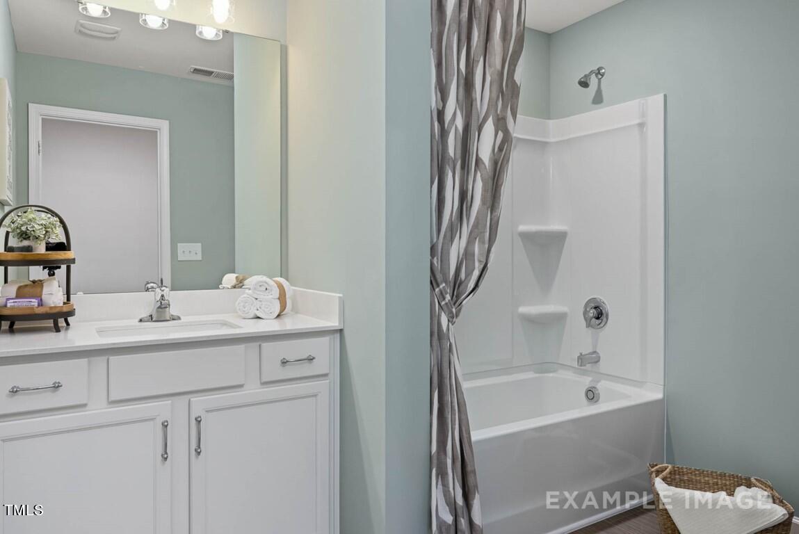 225 Highland Ridge Lane Knightdale, NC 27545 - Photo 37 of 38 a bathroom with a sink a toilet and shower
