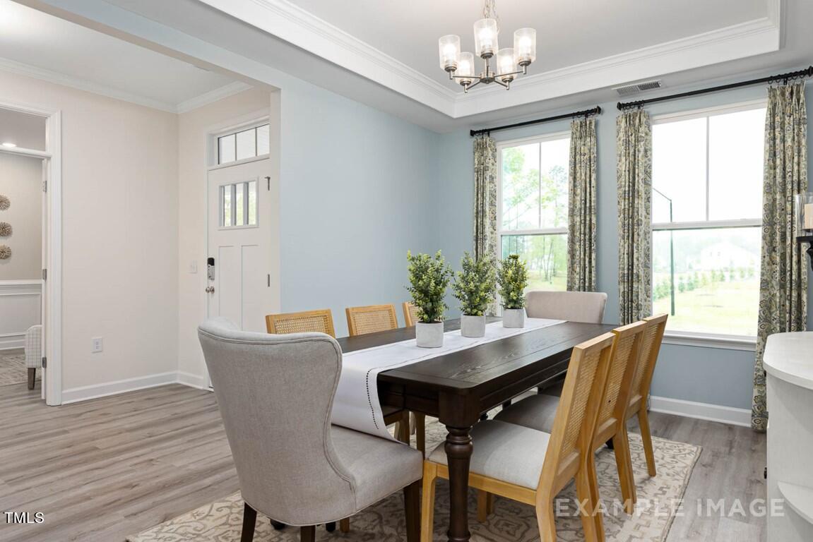 225 Highland Ridge Lane Knightdale, NC 27545 - Photo 9 of 38 a view of a dining room with furniture window and wooden floor
