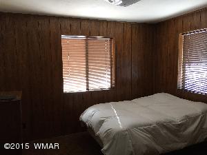 6 Cr 2084 Alpine, AZ 85920 - Photo 11 of 25 a bedroom with a bed and a window