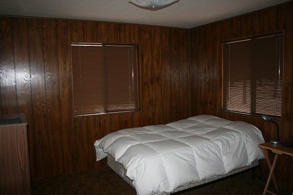 6 Cr 2084 Alpine, AZ 85920 - Photo 21 of 25 a bed sitting in a bedroom next to a wooden door