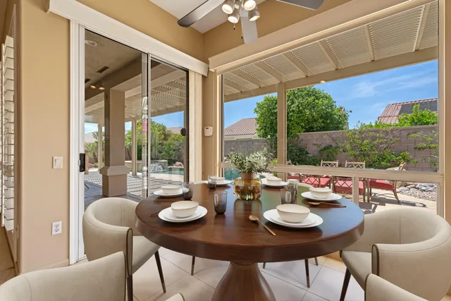 a dining room with furniture window and outside view