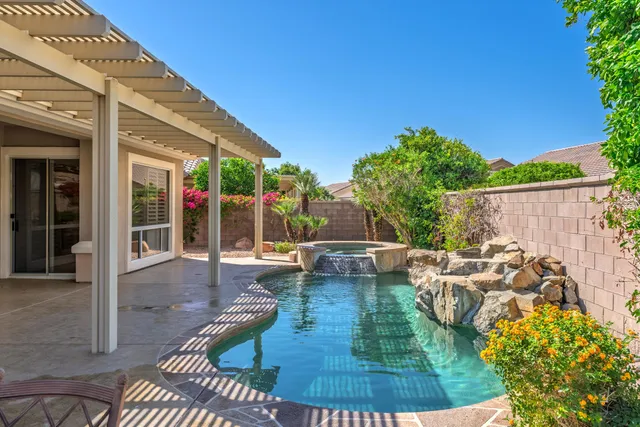 a view of a swimming pool with sitting area