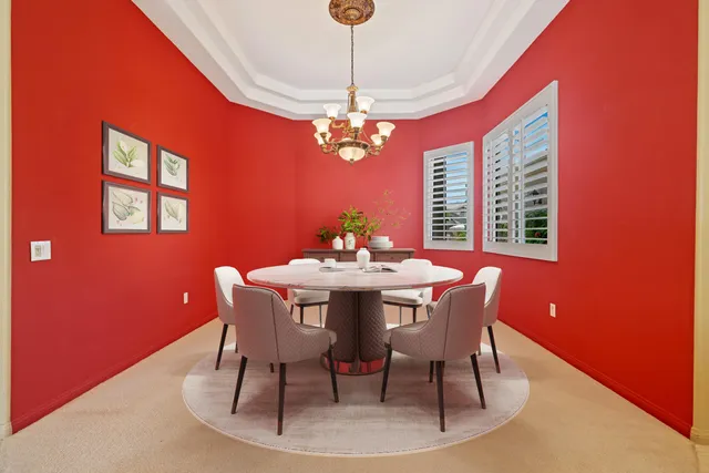 a dining room with furniture a chandelier and window