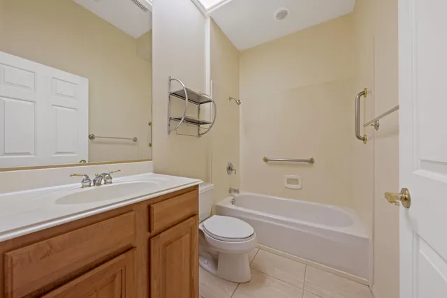 a bathroom with a sink mirror and toilet