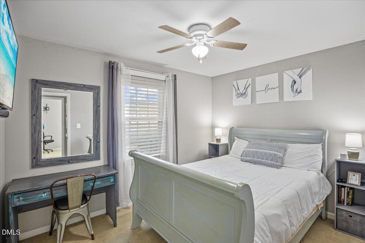 107 Claymont Road Louisburg, NC 27549 - Photo 10 of 30 a bedroom with a large bed and a window