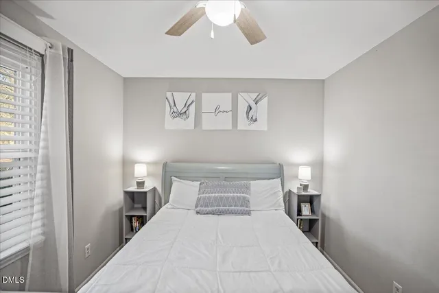 a bedroom with a large bed and a window