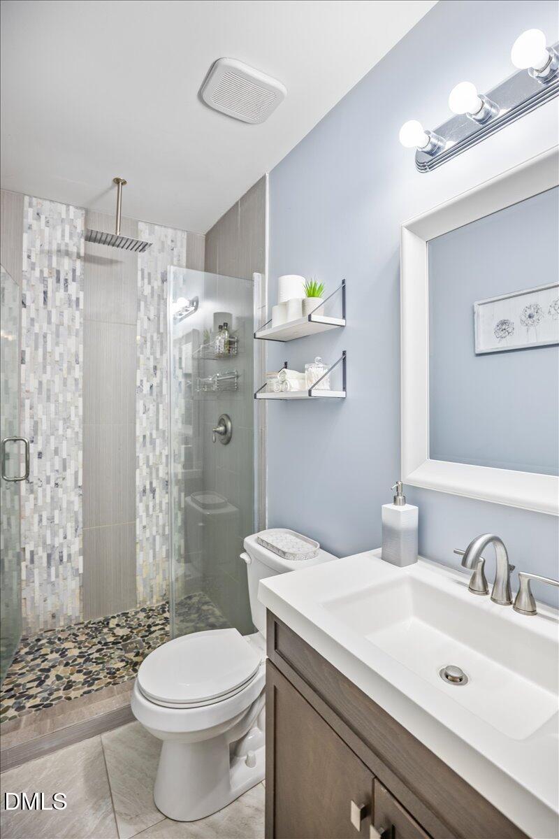 107 Claymont Road Louisburg, NC 27549 - Photo 12 of 30 a bathroom with a sink toilet and shower