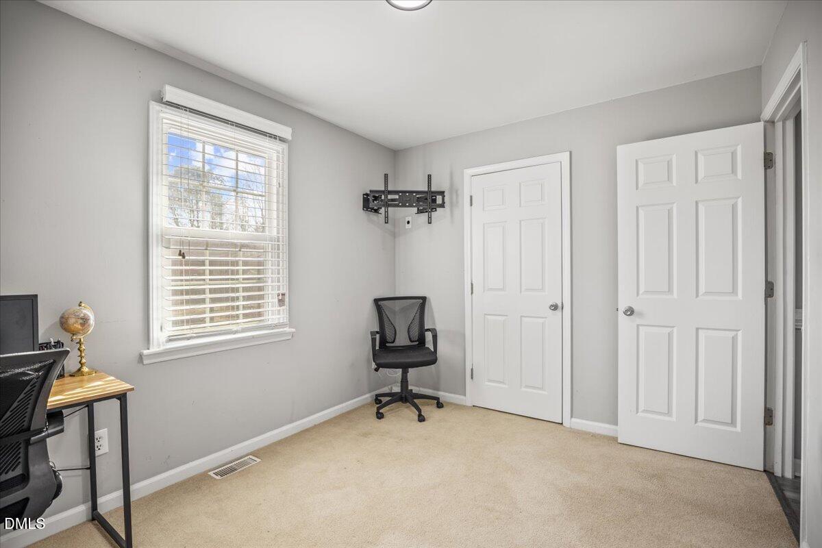 107 Claymont Road Louisburg, NC 27549 - Photo 14 of 30 a view of a workspace with furniture and a window
