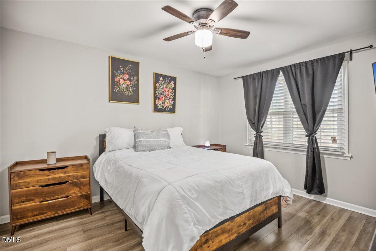 107 Claymont Road Louisburg, NC 27549 - Photo 16 of 30 a bedroom with a bed and a large window