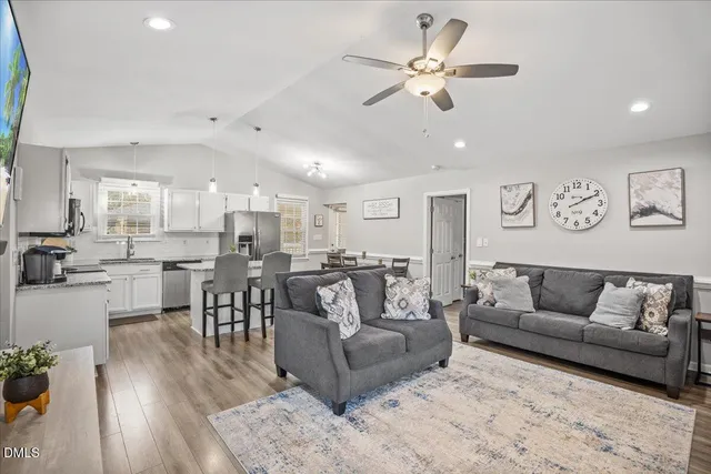 a living room with furniture kitchen view and a dining table