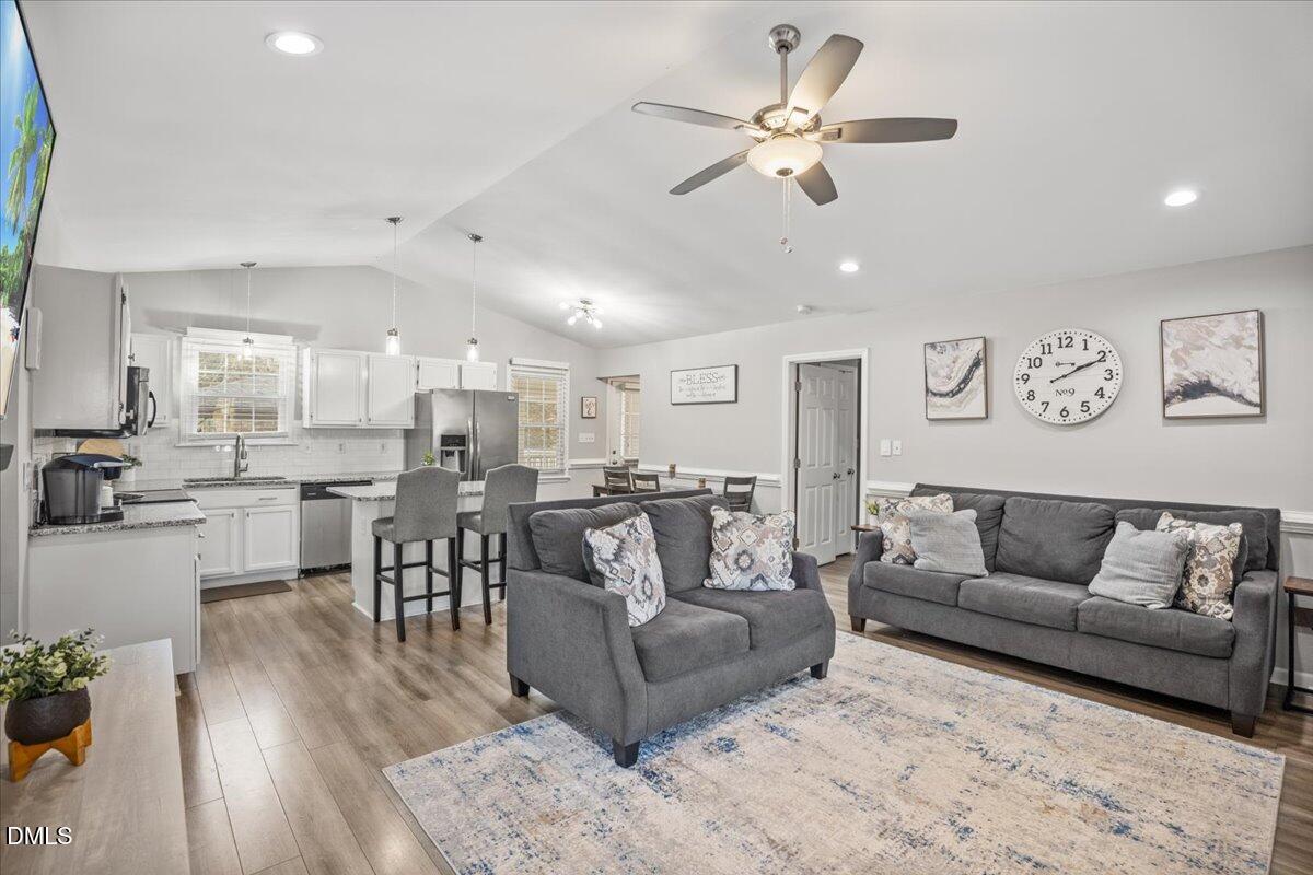 107 Claymont Road Louisburg, NC 27549 - Photo 2 of 30 a living room with furniture kitchen view and a dining table