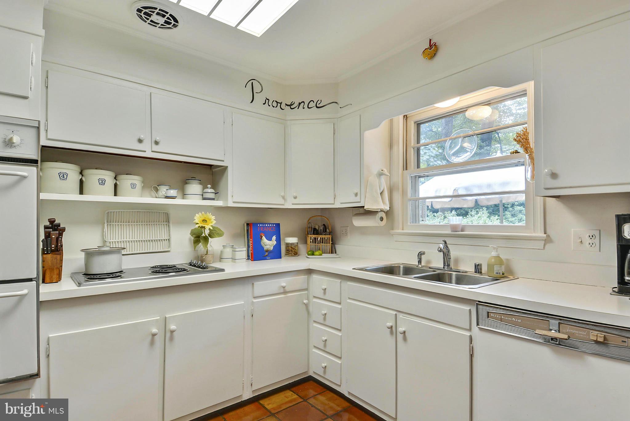 1939 Kimberly Road Silver Spring, MD 20903 - Photo 13 of 30 a kitchen with stainless steel appliances cabinets a window and a sink