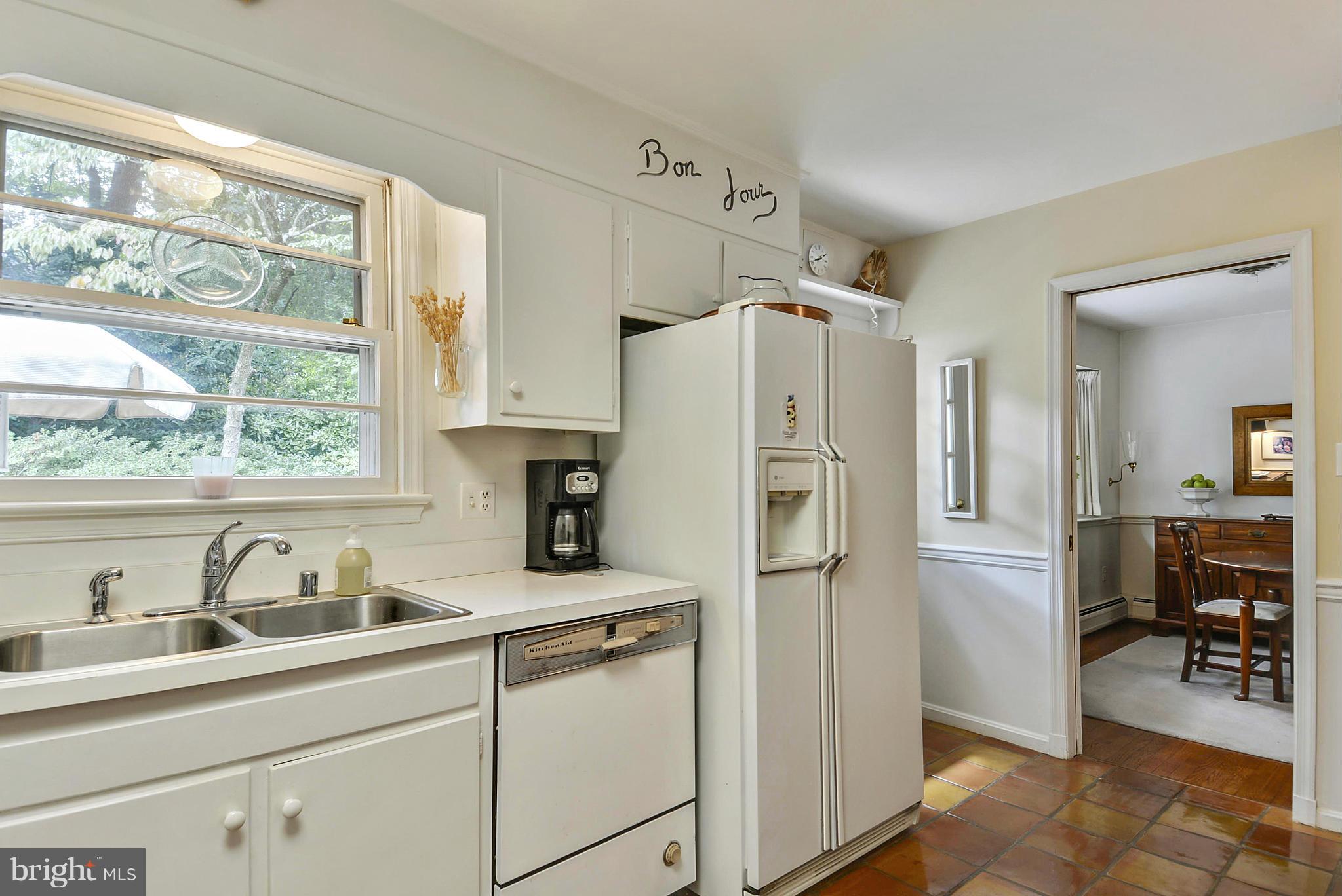 1939 Kimberly Road Silver Spring, MD 20903 - Photo 14 of 30 a kitchen with stainless steel appliances a sink cabinets and a window