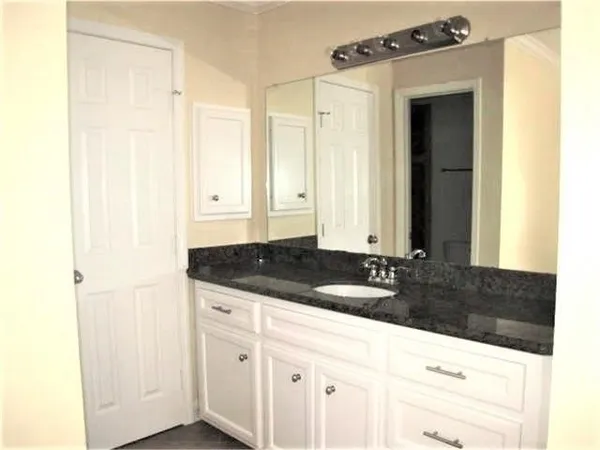 a white toilet sitting next to a bathroom sink