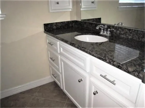a bath tub sitting next to a white toilet