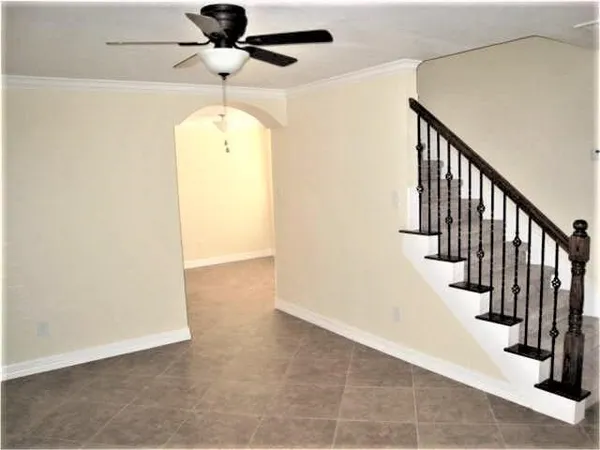 a view of a hallway with wooden floor and staircase