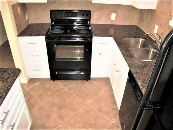 a kitchen with a stove and a refrigerator