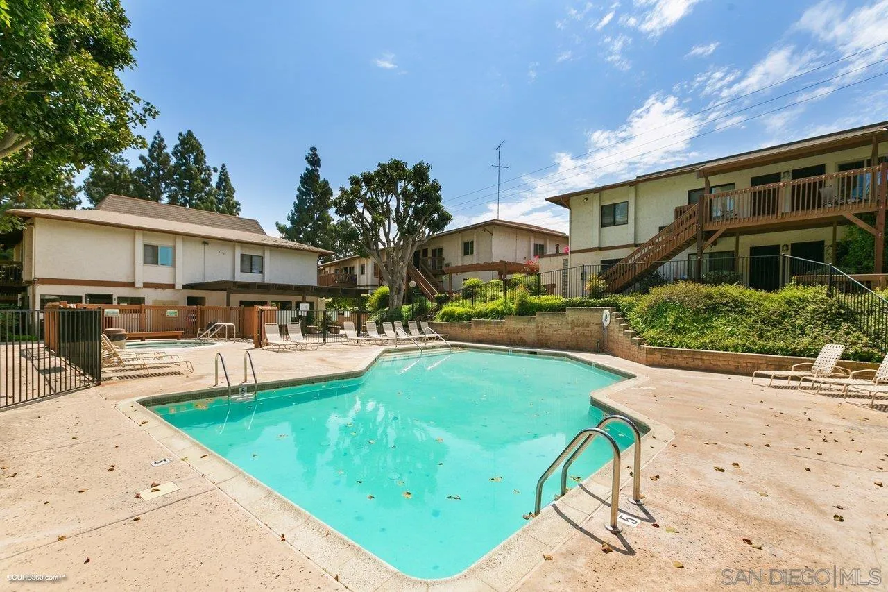 6394 Rancho Mission Road, Unit 106 San Diego, CA 92108 - Photo 15 of 23 a front view of a house with swimming pool and sitting area