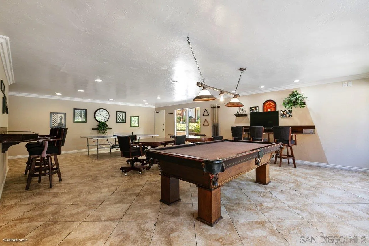 6394 Rancho Mission Road, Unit 106 San Diego, CA 92108 - Photo 19 of 23 a room with lots of furniture and painting on the wall