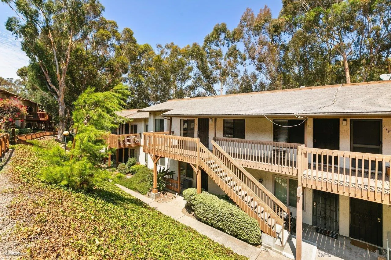 6394 Rancho Mission Road, Unit 106 San Diego, CA 92108 - Photo 22 of 23 a view of a house with a large window and wooden fence