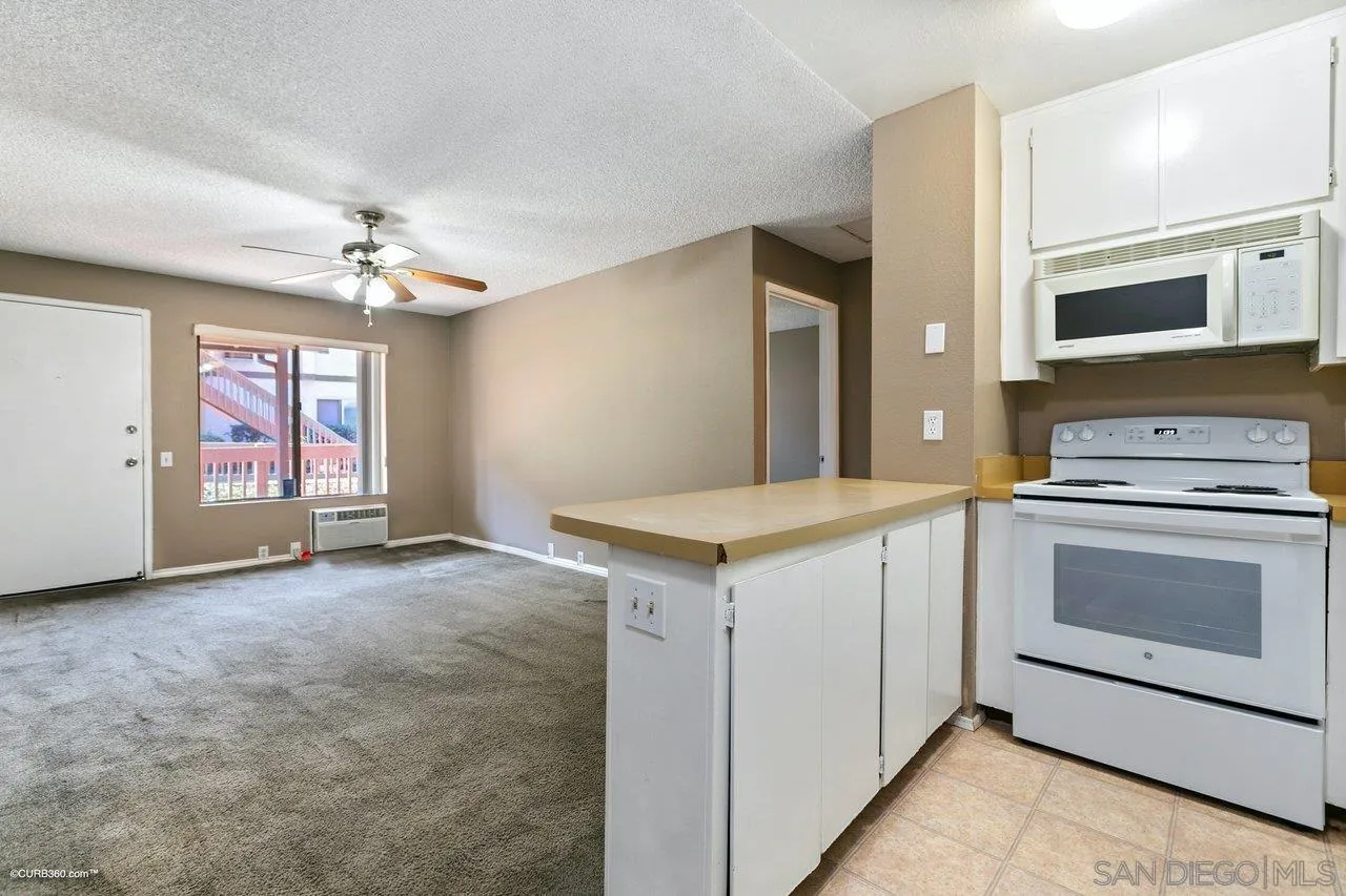 6394 Rancho Mission Road, Unit 106 San Diego, CA 92108 - Photo 5 of 23 a view of a kitchen with a sink and dishwasher a stove top oven