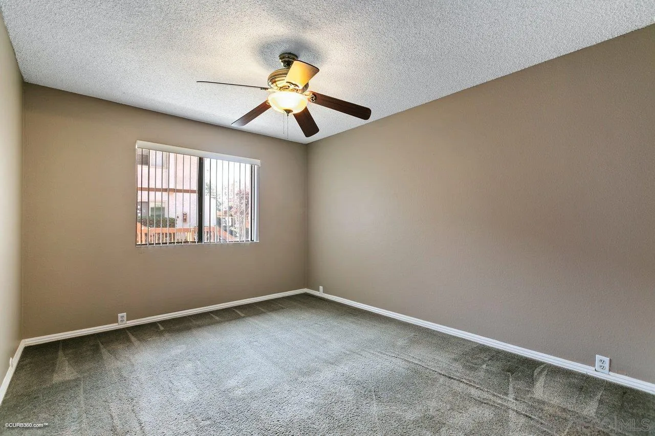 6394 Rancho Mission Road, Unit 106 San Diego, CA 92108 - Photo 9 of 23 a view of an empty room with a window