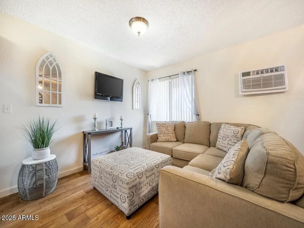 2305 East Main Street, Unit 1 Mesa, AZ 85213 - Photo 2 of 12 a living room with furniture and a flat screen tv